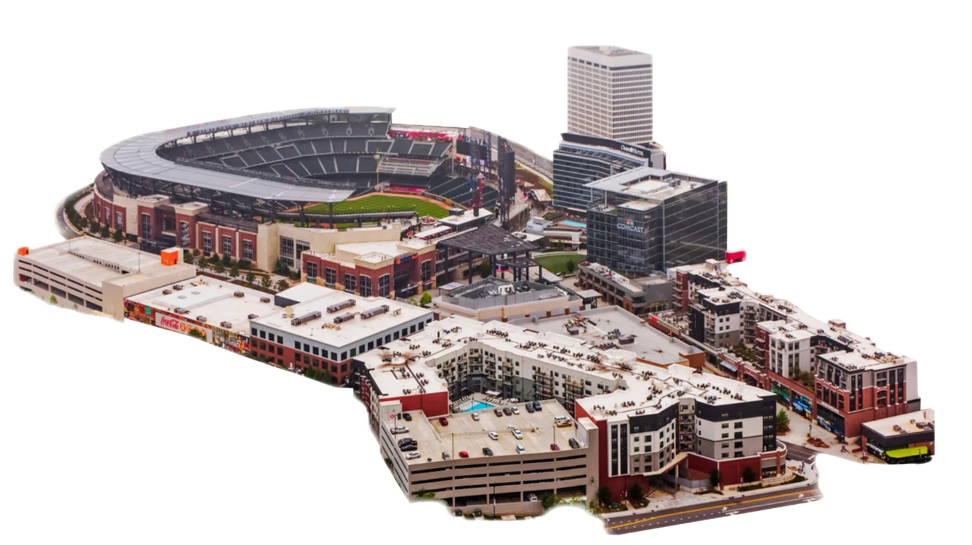 Aerial view of the district around a modern ballpark showing hotels, offices, multifamily, retail and parking — a sports-anchored mixed-use district